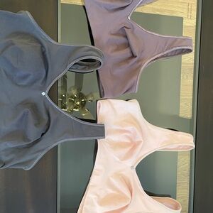 Set of Three Breezies Bras in dark grey, soft pink, and Purple size large